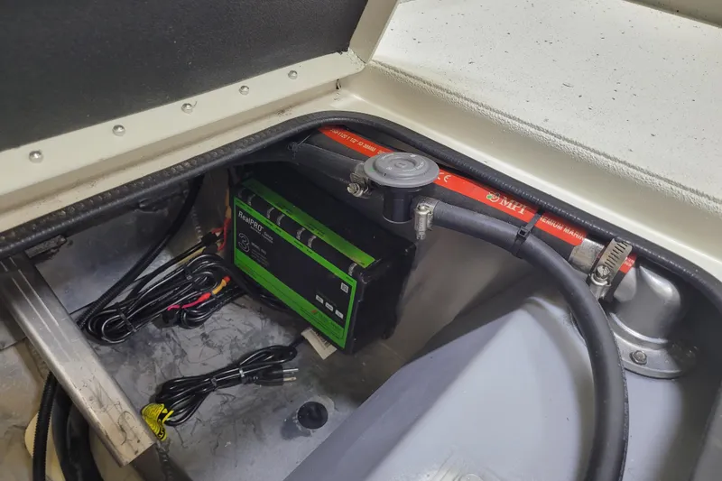 Slide: The Image of 2025 Ranger RB210 battery compartment with RealPRO charger and wiring. - 12
