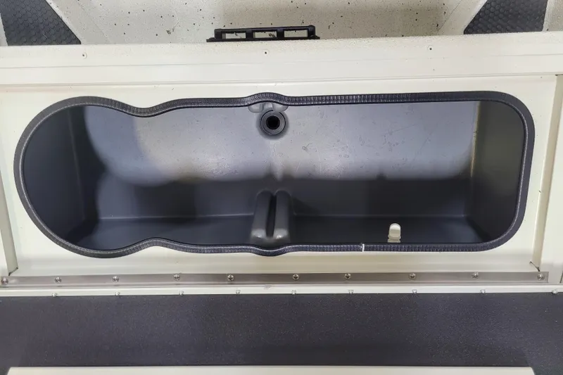 Slide: The Image of 2025 Ranger RB210 boat storage compartment, open and empty, with a sleek black interior. - 19