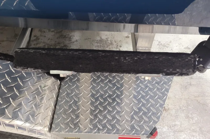 Slide: The Image of Diamond plate metal surface on a 2025 Ranger RB210 boat trailer. - 2