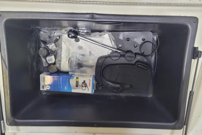 Slide: The Image of Storage compartment of 2025 Ranger RB210 with various boating accessories and equipment. - 20