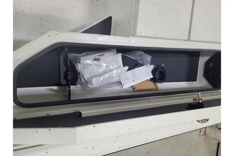 Slide: The Image of Storage compartment of 2025 Ranger RB210 boat with accessories and documents. - 21