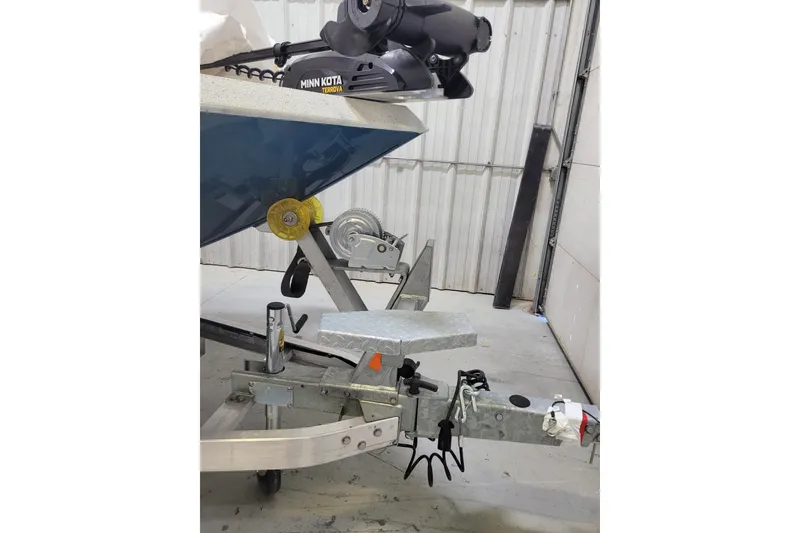 Slide: The Image of 2025 Ranger RB210 boat trailer with Minn Kota Terrova motor in a garage setting. - 29