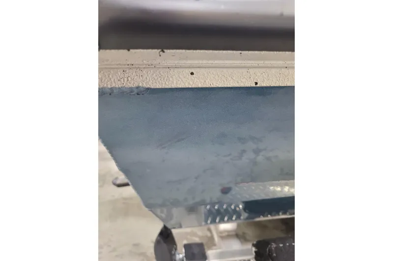 Slide: The Image of 2025 Ranger RB210 boat hull detail with textured surface and metallic finish. - 4