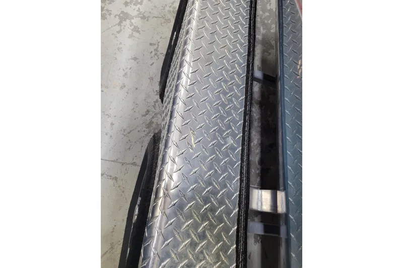 Slide: The Image of Diamond plate surface on 2025 Ranger RB210, showcasing durable metal texture. - 5