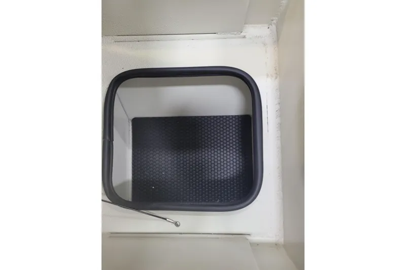 Slide: The Image of Ranger RB210 2025 model, interior storage compartment with black textured mat. - 6