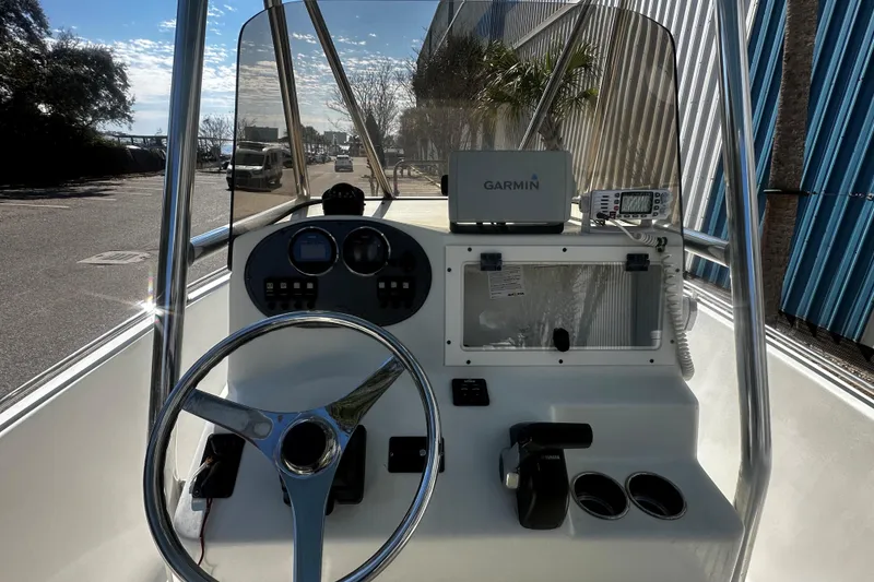 Slide: The Image of 2009 Sea Hawk 210 boat dashboard with Garmin navigation system and steering wheel. - 11
