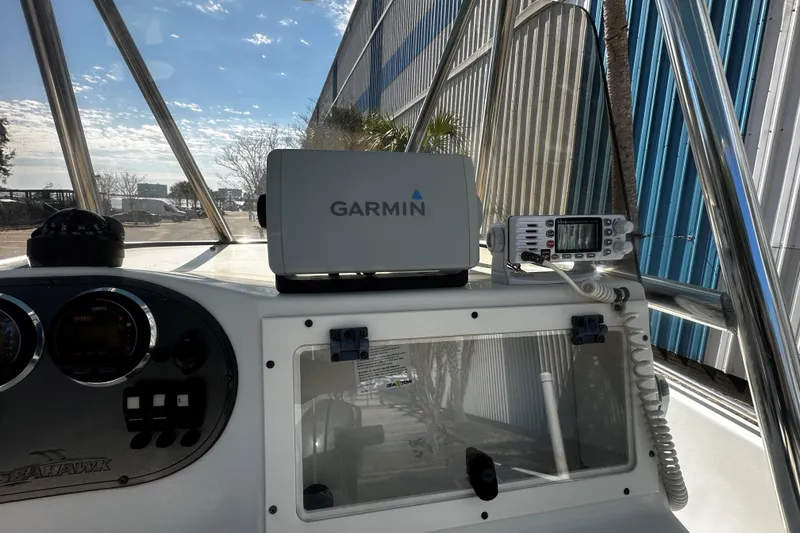 Slide: The Image of 2009 Sea Hawk 210 boat dashboard with Garmin navigation and communication equipment. - 12