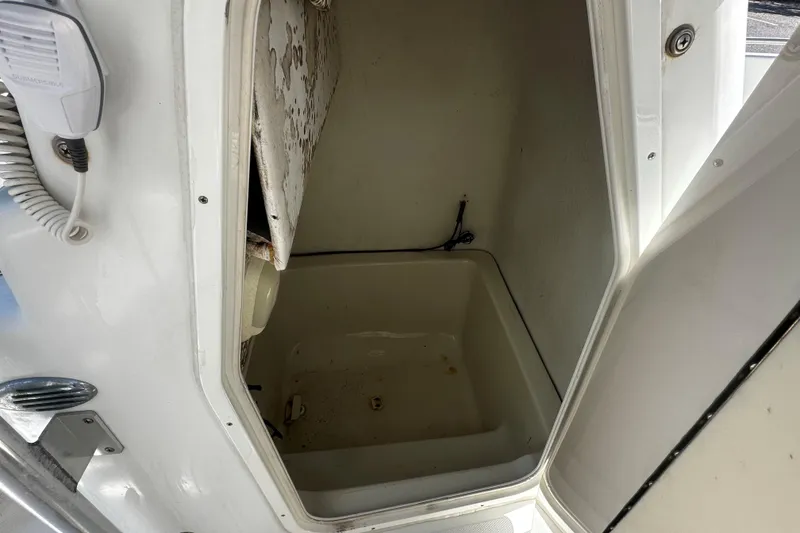 Slide: The Image of Open storage compartment on a 2009 Sea Hawk 210 boat, showing interior details. - 7