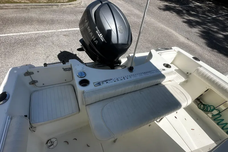 Slide: The Image of 2009 Sea Hawk 210 boat with Yamaha outboard motor, featuring white seating and deck. - 9