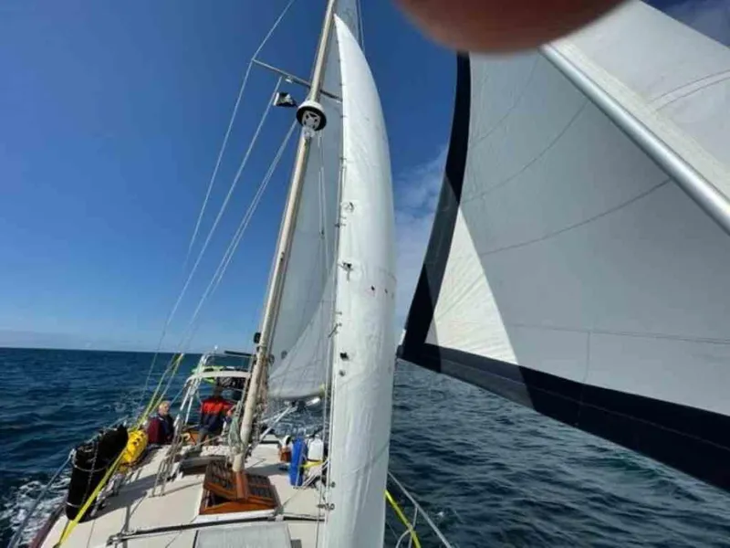 Slide: The Image of 1976 Ericson 36C sailboat navigating open sea. - 10