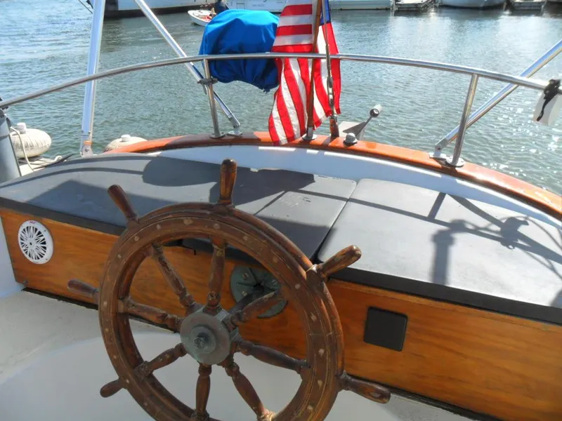 Slide: The Image of Steering wheel of a 1976 Ericson 36C yacht with American flag. - 17