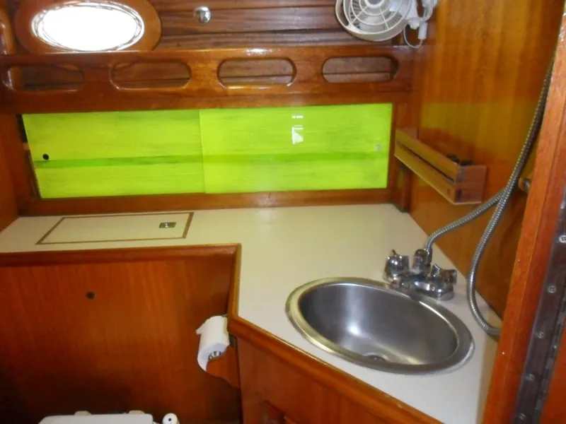 Slide: The Image of Interior of 1976 Ericson 36C yacht with sink and wood paneling. - 32