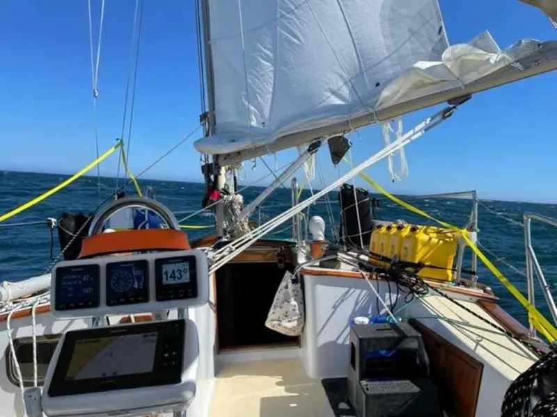 Slide: The Image of 1976 Ericson 36C sailboat navigating open waters. - 9