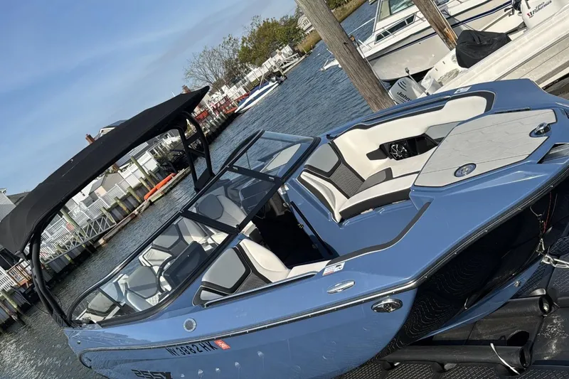 The Image of 2024 Yamaha 255XE boat docked, featuring sleek design and spacious seating. - 1