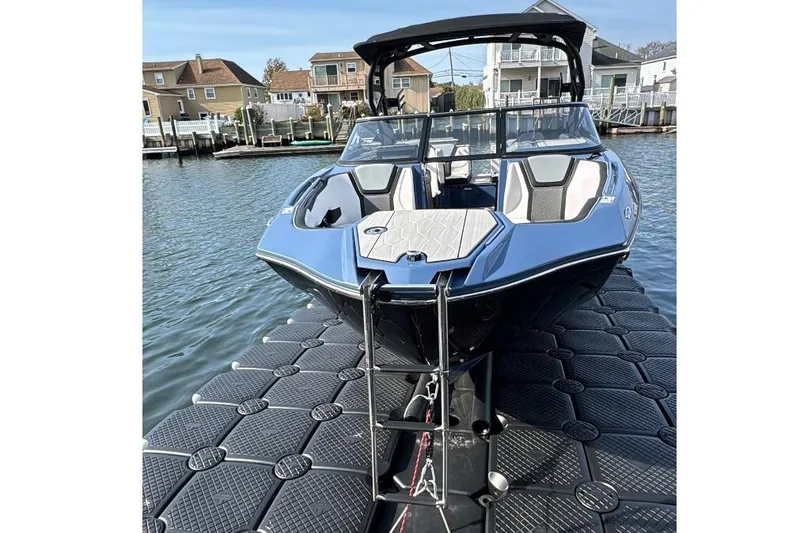 Slide: The Image of 2024 Yamaha 255XE boat docked on water, showcasing sleek design and modern features. - 4