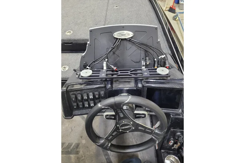 Slide: The Image of 2025 Triton 21XP boat dashboard with steering wheel and control panel. - 11