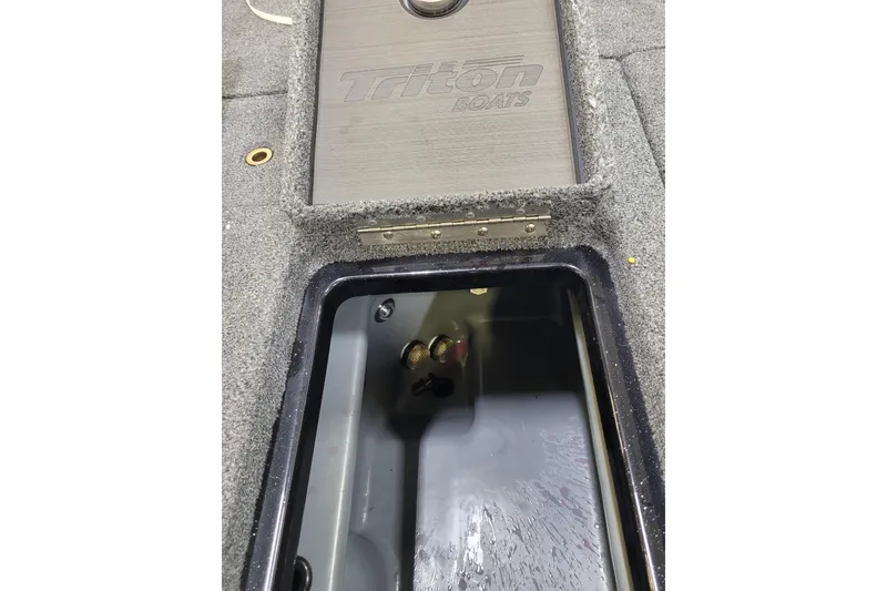 Slide: The Image of 2025 Triton 21XP boat storage compartment with open lid, showcasing interior details. - 15