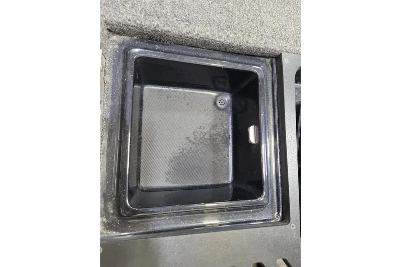 Slide: The Image of 2025 Triton 21XP boat storage compartment with textured interior and drainage feature. - 2