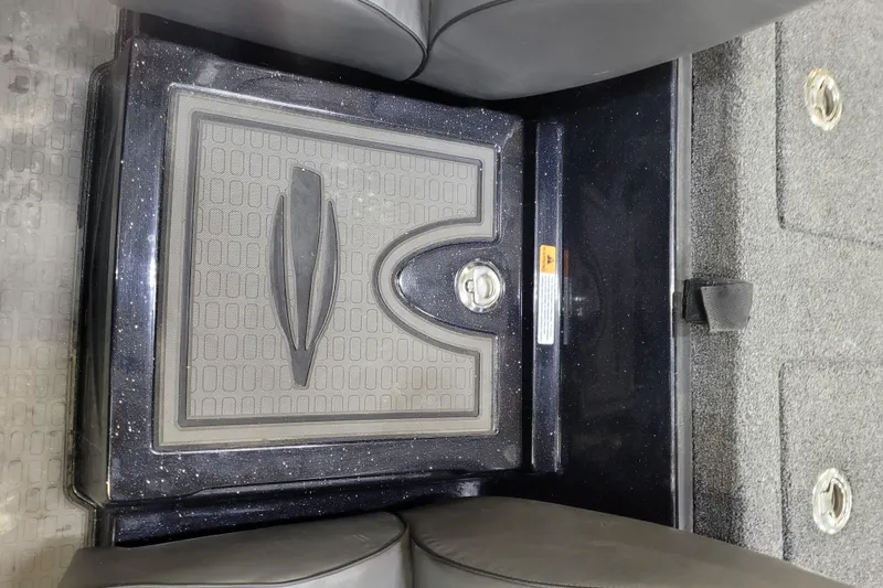 Slide: The Image of Interior view of 2025 Triton 21XP boat, featuring a storage compartment between seats. - 22