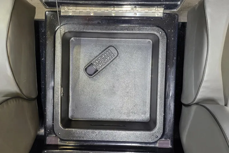 Slide: The Image of Storage compartment in 2025 Triton 21XP boat with remote control inside. - 23