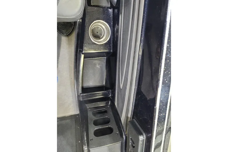 Slide: The Image of Interior view of 2025 Triton 21XP, featuring cup holder and storage compartments. - 25