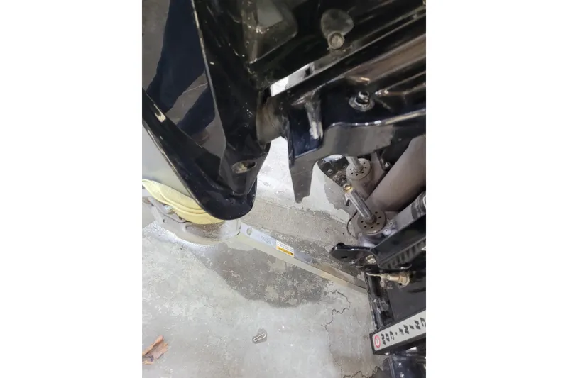 Slide: The Image of Close-up of 2025 Triton 21XP boat engine components in a garage setting. - 34