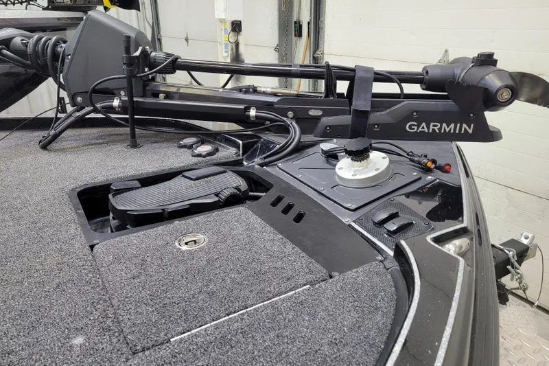 Slide: The Image of 2025 Triton 21XP boat deck with Garmin trolling motor and foot pedal controls. - 51