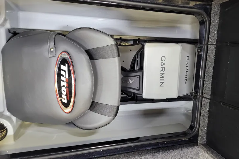 Slide: The Image of 2025 Triton 21XP boat storage with Garmin equipment and Triton-branded seat. - 8