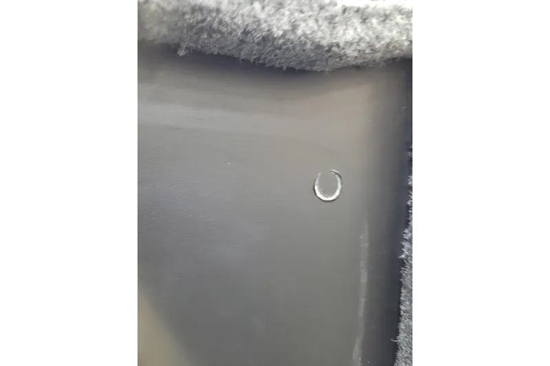 Slide: The Image of Close-up of Triton 21XP 2025 interior detail with textured surface and small circular mark. - 9