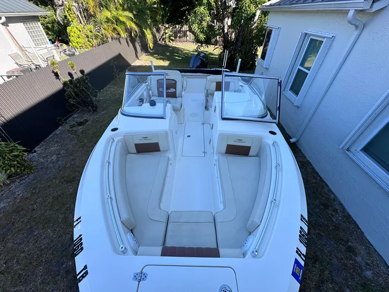 Slide: The Image of 2022 Cobia 220 Dual Console boat parked in a garden. - 10