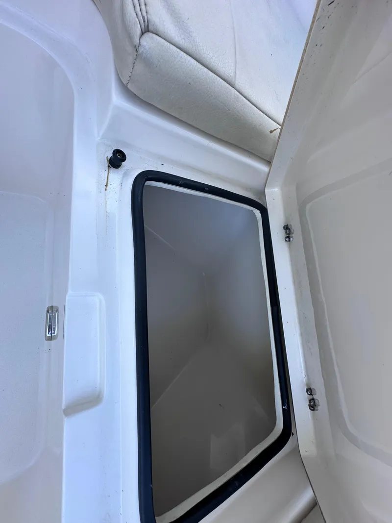 Slide: The Image of Open storage compartment in Cobia 220 Dual Console boat, 2022 model. - 26