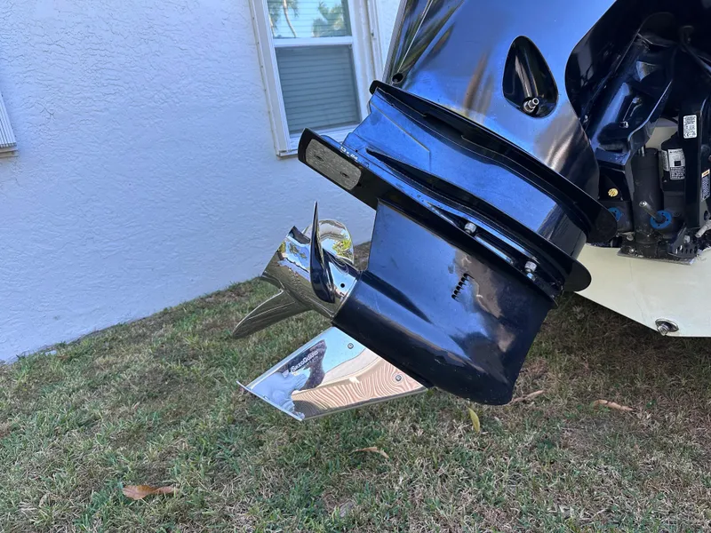 Slide: The Image of Outboard motor of a 2022 Cobia 220 Dual Console boat. - 6