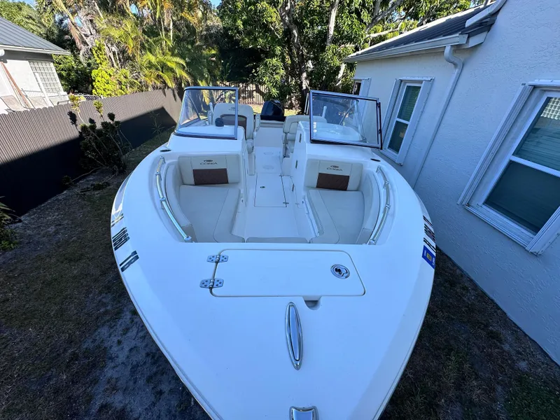 Slide: The Image of 2022 Cobia 220 Dual Console boat parked in a yard. - 9