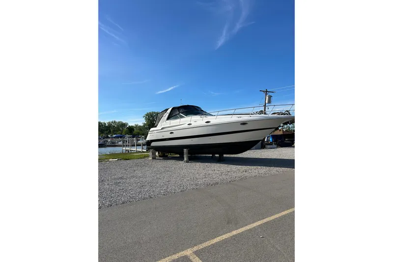 Slide: The Image of 2000 Cruisers 3870 yacht on dry dock under clear blue sky. - 1