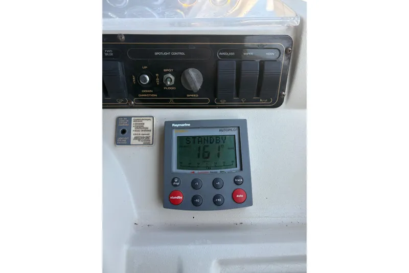 Slide: The Image of Control panel of a 2000 Cruisers 3870 boat with Raymarine autopilot display. - 15