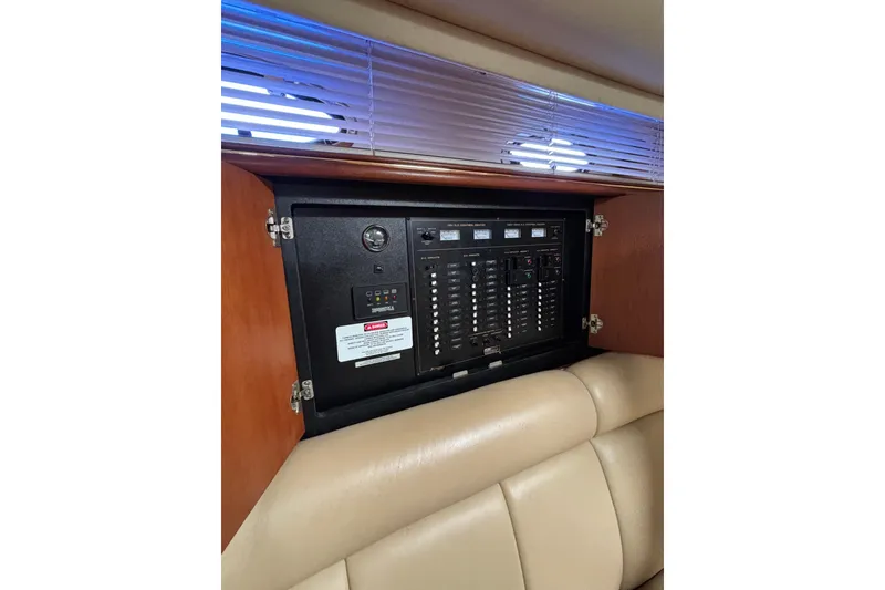 Slide: The Image of Electrical panel inside a 2000 Cruisers 3870 yacht, featuring switches and gauges. - 37