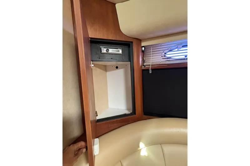 Slide: The Image of Interior of 2000 Cruisers 3870 yacht showing a wooden cabinet with a safe. - 40