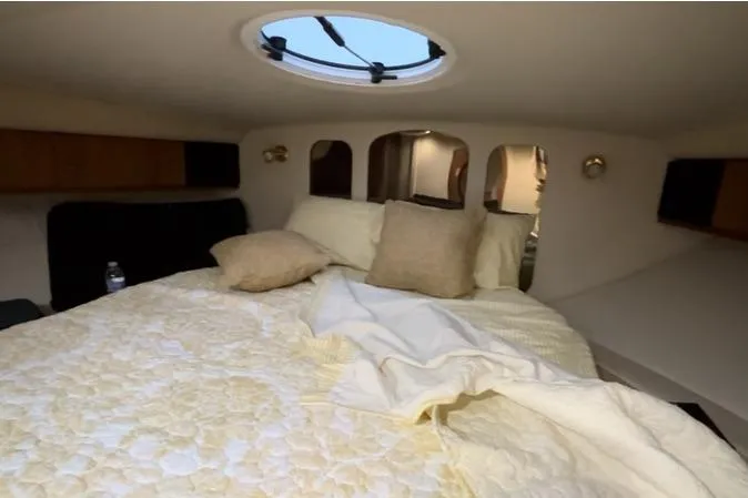 Slide: The Image of Cozy cabin interior of 2000 Cruisers 3870 yacht with bed and porthole. - 43