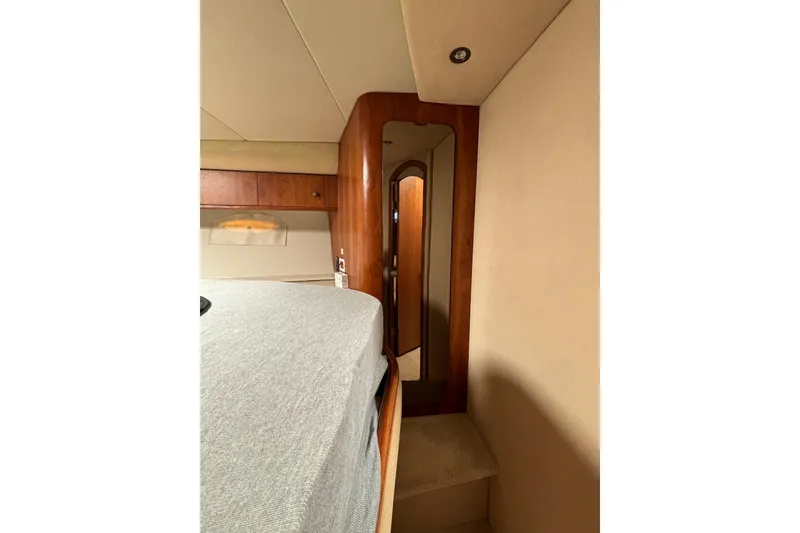 Slide: The Image of Interior of 2000 Cruisers 3870 yacht, featuring a cozy cabin with wood accents. - 47