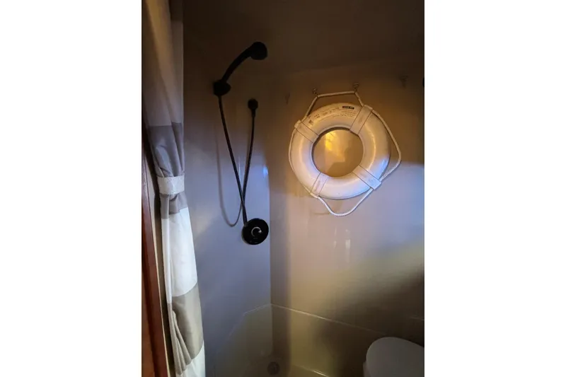 Slide: The Image of Shower area in 2000 Cruisers 3870 boat with lifebuoy and curtain. - 51