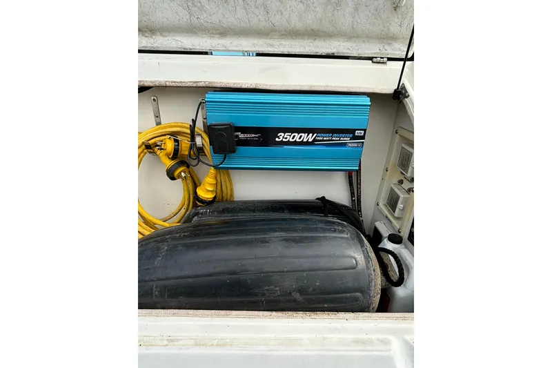 Slide: The Image of Power inverter and cables in a 2000 Cruisers 3870 boat compartment. - 59