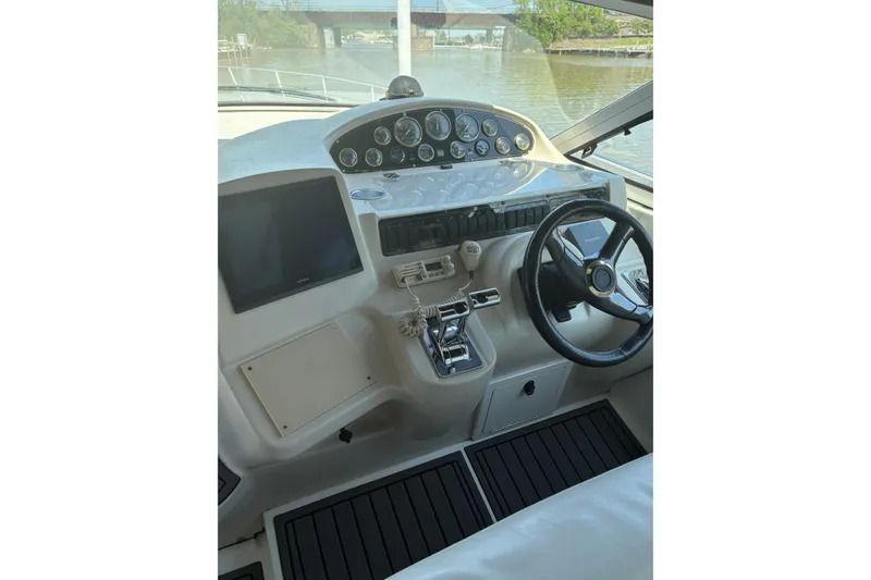 Slide: The Image of Cockpit of 2000 Cruisers 3870 yacht with steering wheel and control panel. - 10