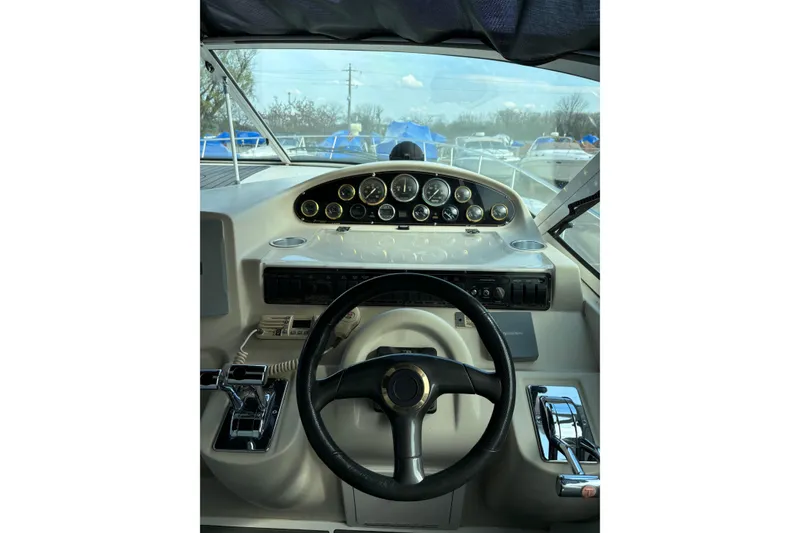 Slide: The Image of Cockpit view of a 2000 Cruisers 3870 boat, featuring steering wheel and control panel. - 12