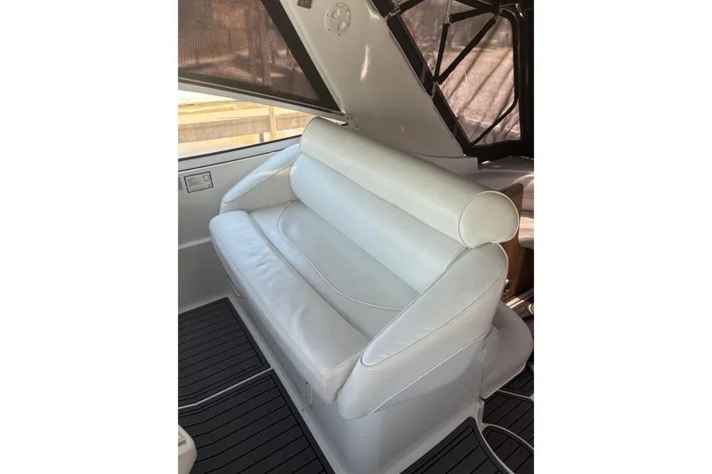 Slide: The Image of White leather seating on a 2000 Cruisers 3870 yacht, featuring sleek design and comfort. - 17