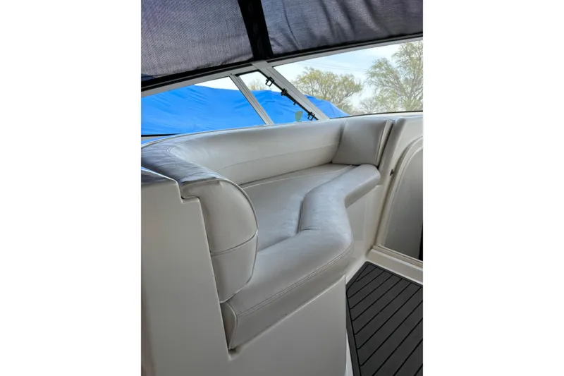 Slide: The Image of Luxurious seating on a 2000 Cruisers 3870 yacht, featuring sleek white upholstery. - 18