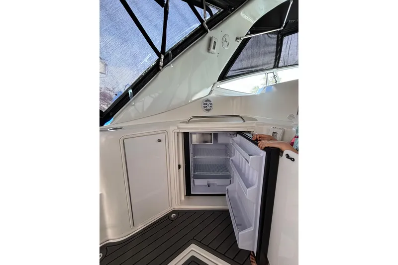 Slide: The Image of 2000 Cruisers 3870 yacht interior with open refrigerator, showcasing storage space. - 26