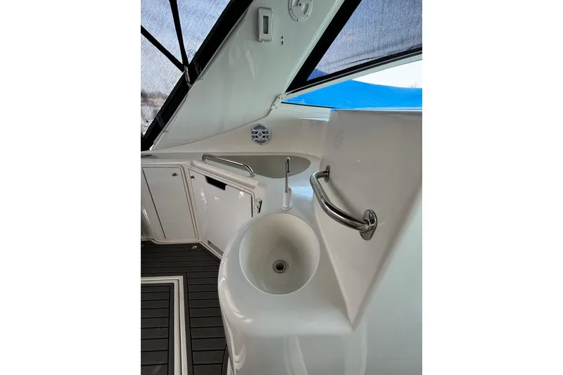 Slide: The Image of 2000 Cruisers 3870 yacht interior with sink and handrail, featuring sleek design elements. - 27