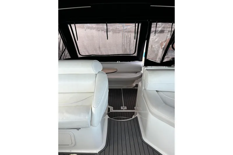 Slide: The Image of Interior of 2000 Cruisers 3870 yacht with white seating and dark flooring. - 28