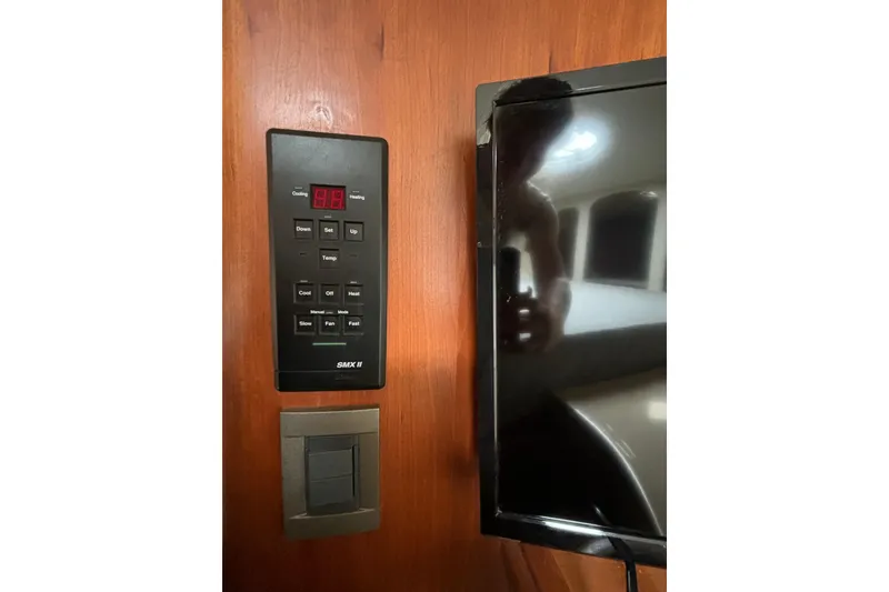 Slide: The Image of Control panel and screen inside a 2000 Cruisers 3870 yacht cabin. - 35