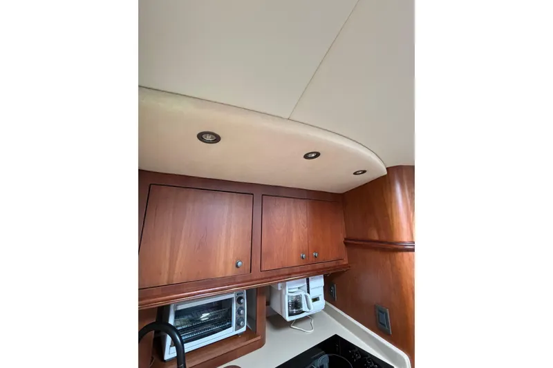Slide: The Image of Interior of 2000 Cruisers 3870 yacht kitchen with wooden cabinets and appliances. - 41